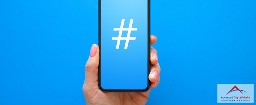 ADMS - A person holding a phone that has a hashtag image on the screen