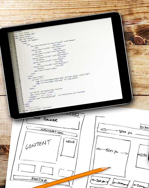 ADMS Website wireframe sketch and programming code on digital tablet